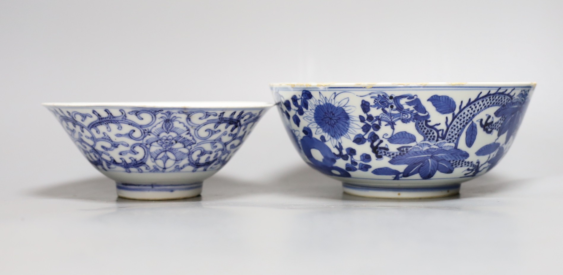 A Chinese blue and white dragon bowl, another blue and white bowl and a saucer, 19th century, largest 20.5cm